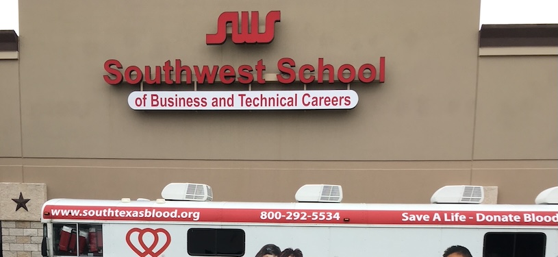 Southwest School campus building with a blood donation bus in front of it